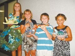Stephanie Cates, Samantha Cates, Bryan Cates and 
Kennedy Cates display some of the homemade items they are entering in the Rogers County Free Fair.