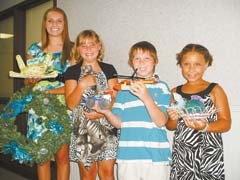 Stephanie Cates, Samantha Cates, Bryan Cates and 
Kennedy Cates display some of the homemade items they are entering in the Rogers County Free Fair.