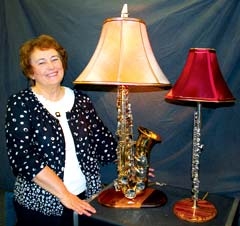 Laurann Farris, chair of Heart of Broken Arrow Arts, Crafts &amp; Antiques Fair, shows off a couple of the musical instrument lamps that will be exhibited by crafter Art Hartman.
