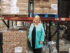 Eileen Bradshaw, executive director of the Community Food Bank of Eastern Oklahoma, in the warehouse with canned items used for the Foods for Kids program.