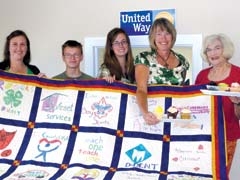 Donna Patterson, Jacob Daley, Michaela Branen, Mendy Stone and Donna Ross hope this United Way quilt, made by members of the Rogers County 4-H Club, will draw a huge bid at the 2011 Chocolate Affair.