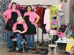 Princess and pirate costumes, rock star outfits, and ­cowboy gear surround Talk of the Town owner Deborah Woodard, far right, and event coordinators, Tiffany ­Goodwin, left, and Shelbi Woodson, seated. The new party company and event center offers a full range of services for making dreams and themes come true.