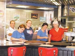 Home cooked comfort meals – breakfast, lunch and dinner – are served every day by the friendly staff of Cafe USA. (L to R): Sam, Lisa, Leeann, Shell and Linda.