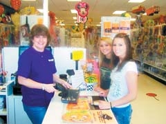 Angie Mott helps local clients Emily and Sarah, who had searched all over for black napkins and found them at Party Depot.