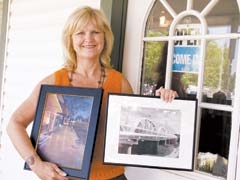 Jenks Chamber of Commerce President Annette Bowles holds examples of fine art available at Art on Main.