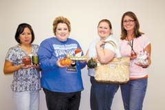 The ladies at Glenpool Chamber of Commerce show some of the “gifts” that will be available at Glenpool Games, Gab and Gifts Galore. (L to R): Kathy Smith, Stephanie ­Rommohan, Tammy Hendrickson and LeaAnn Golden.
