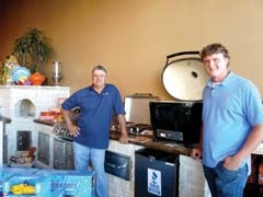 Danny Kingsley and his son Josh, next to a Primo smoker available at Pools Plus.