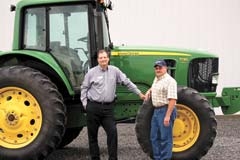 RCB Bank Loan Officer Ray McCartney (left) with Merl Troyer, farmer. Picture was taken at Troyer’s farm outside Pryor.