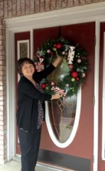 Patsy Terry readies the storefront of Arrow Flowers for the Broken Arrow Holiday Tea Off celebration.