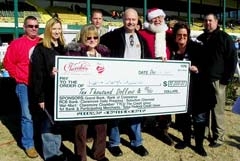 Members of the Claremore Chamber board presented a $10,000 check to last year’s grand prize winners, Kenneth and Sheryl Lewis, at Will Rogers Downs Grandstands. Their winning ticket was from Reasor’s.