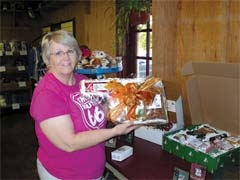 Hazel Ward shows off one of the great Oklahoma-themed corporate gift baskets available at The Nut House.