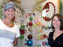 Festival of Trees committee members Tammy Thomas (left) and Cari Bohannan purchase decorations to prepare table centerpieces that will be auctioned off at the annual fundraiser to benefit Safenet Services.