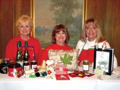Tulsa Herb Society President Patsy Wynn and her two ­committee chairs, 
Eve Joseph (middle) and Lois Galpin (left), display goods for Carols and Crumpets.