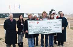 Members of the Claremore Chamber board presented a $10,000 check to last year’s
grand prize Santa Cash winner, Kim Massman, at Will Rogers Downs Grandstands. (L to R):&amp;#8200;Tony Cavallo and Ali Aguilar (Cherokee Casino Will Rogers Downs), Julie Adams, Pam Steffens, Kim Massman, Kelli Sellers, Santa Claus, and Dell Davis.