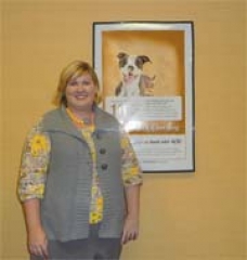 Savannah Haddock, marketing associate of RCB Bank, with the poster for their new “my CashBack” program.