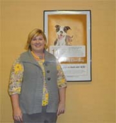 Savannah Haddock, marketing associate of RCB Bank, with the poster for their new “my CashBack” program.