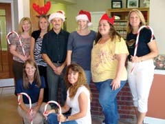 Jingle Bell Sweepstakes committee members and staff members from Scott Breland Dental Office, a participating Jingle Bell Merchant. (Standing, L to R): Julie Clayton, Sara Harper, Scott Breland, Alecia Boaz, Shauna Goins, Cindy McDonald, (Kneeling, L to R): Gina Belk and Cassie Inman.