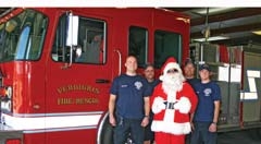 Santa’s reindeer are on vacation until Christmas Eve, so Santa will be hitching a ride on one of the Verdigris fire engines for the parade. (L to R): Andrew Williams, Dave Sykes, Santa Claus, Chief Mike Shaffer and Josh Irby.