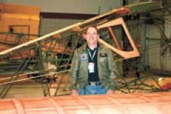 Col. Bob Prater in the hangar with restorations in progress.