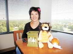 Jami Sullins, Independent Director with Scentsy, shows some Scentsy warmers and a Scent Buddy, Roarbert the Lion.