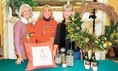 DeDe Boedeker, Patsy Wynn and Erna Schneider display a few of the items that will be available at Carols and Crumpets, including chutneys, vinegars, herbs and crafts.
