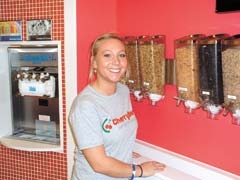 Employee Katie Walker showcases the different 
dry ingredients CherryBerry has to offer.
