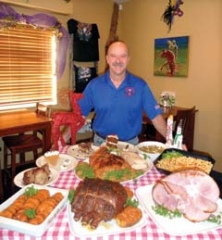 Cajun Ed’s Hebert’s Specialty Meats owner Cajun Ed Richard shows some delectable holiday meal options ­available, ­including turducken, standing rib, spiral sliced ham, corn maque choux and a variety of mouthwatering desserts.