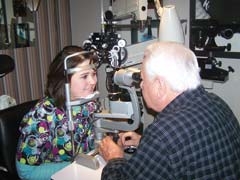 Dr. Hinkle of Primary Eye Care Associates in Owasso gives a patient an eye exam.