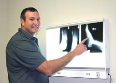 Dr. Steven Hardage at Eastern Oklahoma Orthopedic Center in Claremore points out a stress fracture on a patient’s X-ray.