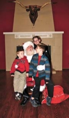 Connor, Logan and Blake Jones put their Christmas order in early when Santa (Neil Thielen) stopped by the Will Rogers Memorial Museum to make plans to slip down the Heritage Gallery chimney the first three Saturdays in December. Admission to the Museum will be free those days.