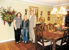 Interior designer Melody Miles of Divine Redesign with happy clients Suzanne and Doug Wright, in their redesigned home.
