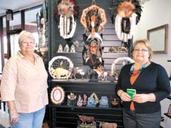 Margaret Bean, employee of Nancy’s Unique Gifts &amp; Cleaners, one of the participants in the Holiday PASSPORT to Cash campaign, and Dianne Bileck-Plants, ­Executive ­Director of the Glenpool Chamber of Commerce. Nancy’s Unique Gifts offers a treasure trove of wonderful gift options, including Native American items (pictured), painted ponies, candles, inspirational gifts from J &amp; J Woodshop, military and teacher gifts, and much more.
