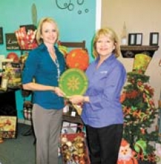 Kallie McGuire and Suzanne Shirey hold the Frankoma plaque that will be awarded to winners in the Sapulpa Chamber Christmas Parade.