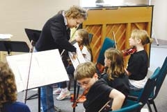 Conductor Melody Garrett leads the children in the Owasso Youth Orchestra.