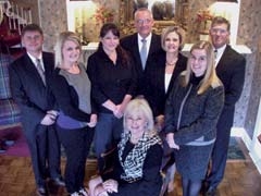 The staff of Rice Funeral Service &amp; Cremation Center: Owner Kathy Dopp (seated) and the staff of Rice Funeral Service (L to R):  Jason Rouk, Erin McElwain, Chandra Krafft, Kenny DeLozier, Gina Wilson, Haley DeLozier and Fred Miehe.