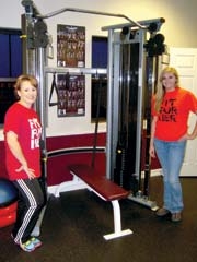 Fit For Her owner Adana Gittelman and staff member Brooklyn Young pause next to the new Functional Trainer.