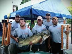 Champion Noodler Kaleb Summers (center) and his noodling team.