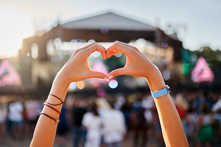 Image of heart hands at concert.